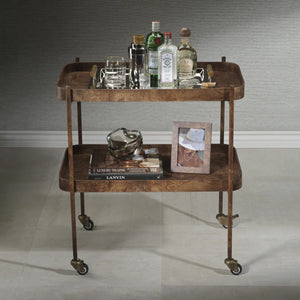 The BENETEAU BAR CART IN BURL WOOD VENEER by ZODAX features a two-tier rectangular design with raised edges, a brown burl veneer finish, and four caster wheels for mobility. Its vintage, elegant style is available for in-store pickup.
