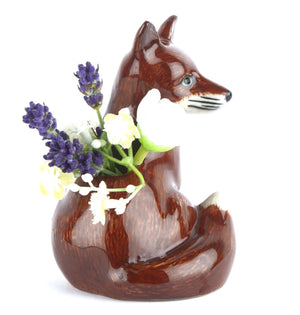 The QUAIL CERAMICS - FOX BUD VASE by QUAIL DESIGNS is a hand-painted stoneware planter with a glossy brown and white finish, featuring alert ears, detailed facial features, and a hollowed back for displaying your favorite plants.