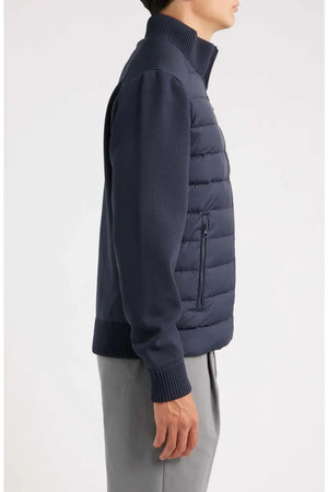 Close-up of a dark blue recycled polyester knit fabric with a uniform ribbed texture featured on the SAVE THE DUCK - SEDUM JACKET IN BLUE.