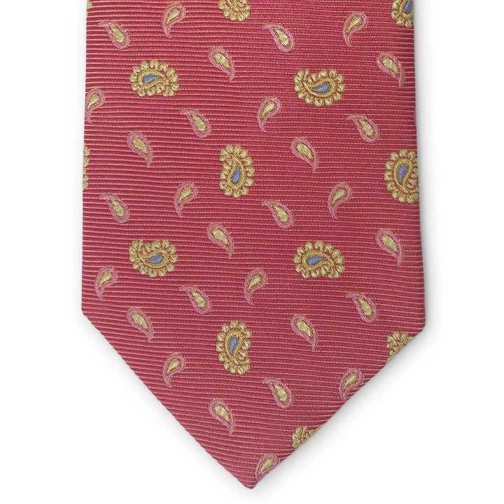 A handmade 100% silk necktie by BIRD DOG BAY, the PETER-BLAIR - BESPOKE HERO PAISLEY SILK TIE features a paisley pattern in red, pink, and yellow, and is displayed rolled on a white background.