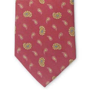 A handmade 100% silk necktie by BIRD DOG BAY, the PETER-BLAIR - BESPOKE HERO PAISLEY SILK TIE features a paisley pattern in red, pink, and yellow, and is displayed rolled on a white background.