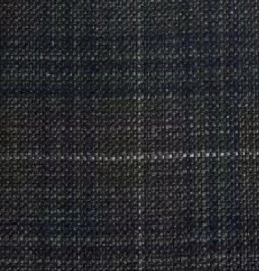 Close-up of the WIGENS - IVY SLIM ITALIAN SOFT CHECK CAP IN GREY by WIGENS, featuring dark gray woven fabric with a subtle check pattern created by intersecting lighter threads. The tightly woven texture has a slightly rough feel, making it an excellent choice for this classic Italian-inspired wool flat cap.