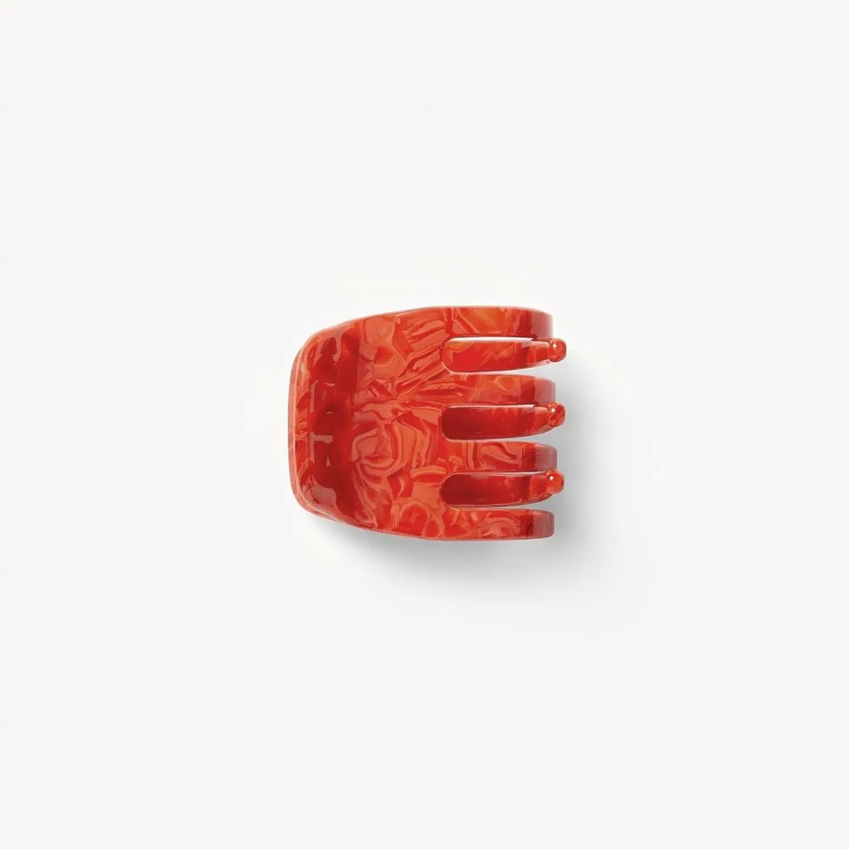 The MACHETE - MINI HAIR CLAW IN POPPY, a handcrafted marbled red claw clip with three prongs, made from Italian acetate, is displayed on a plain white background.