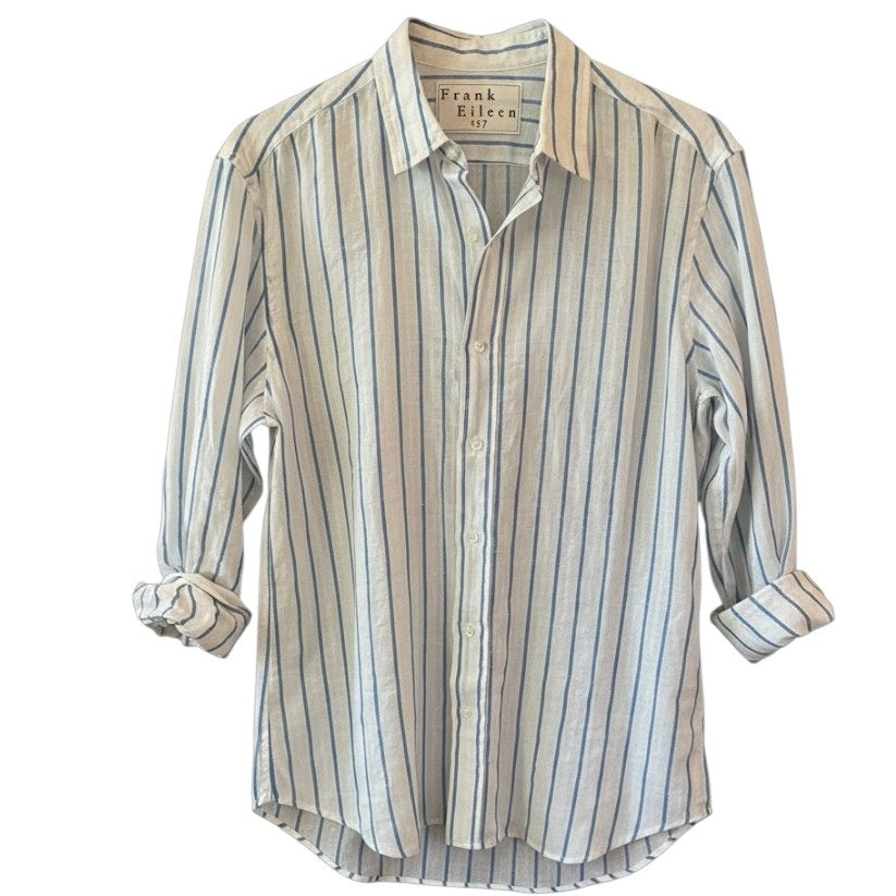 A man stands facing forward and smiling against a white background, wearing FRANK & EILEEN's FINBAR Men's Button Up Shirt in white with turquoise stripes (washed linen) and blue jeans.