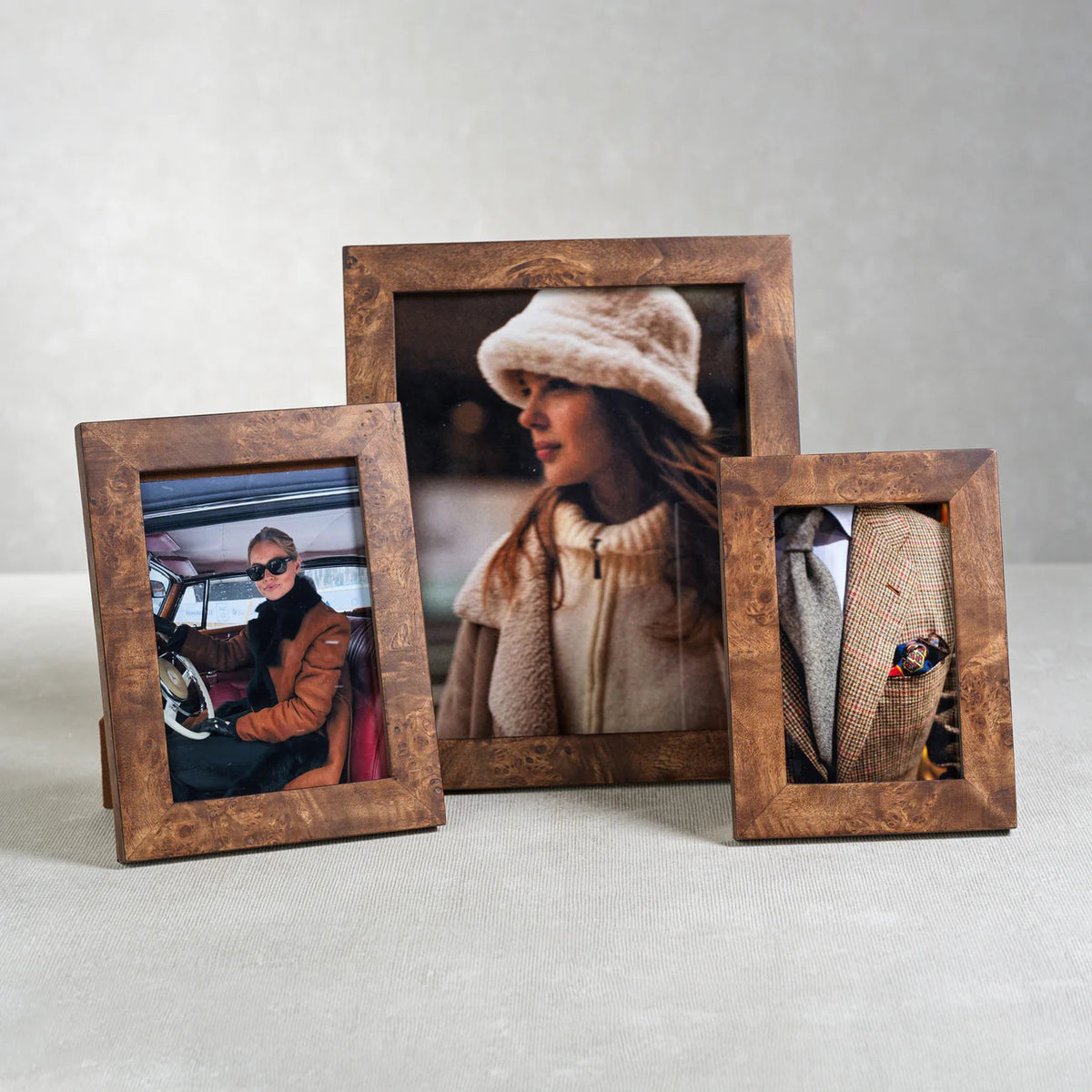 The ZODAX BURL WOOD PHOTO FRAME 8X10 showcases a portrait of a woman in a white fuzzy hat and cream coat, gazing sideways against a softly blurred backdrop.