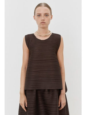 Close-up of MEIMEIJ Plisse Sleeveless Top's dark textured fabric displays a finely woven pattern. The consistent monochrome color and texture, with subtle weave variations, reflect minimalist elegance.