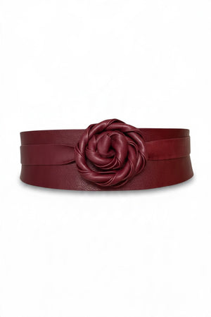 An ADA - LEATHER WRAP BELT IN MALBEC, a wide, deep red leather wrap belt worn over a light-colored dress as a versatile accessory.