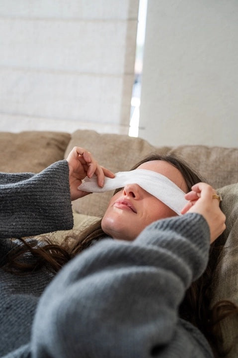 A white box labeled “MADISON AND GREEN - REST YOUR EYES ON THE PLANE” by MADISON GREEN is displayed on a plain white background, accompanied by small containers and two stacked rectangular packages in front. These reusable eye mask sets provide a calming aromatherapy experience for relaxation and comfort.