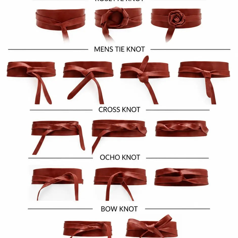An ADA - LEATHER WRAP BELT IN MALBEC, a wide, deep red leather wrap belt worn over a light-colored dress as a versatile accessory.