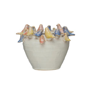 The PLANTER W BIRDS ON RIM by CREATIVE COOP is a ceramic piece made entirely from stoneware, showcasing a smooth, white exterior with small pastel-colored bird sculptures—yellow, pink, and blue—gracefully adorning the rim.