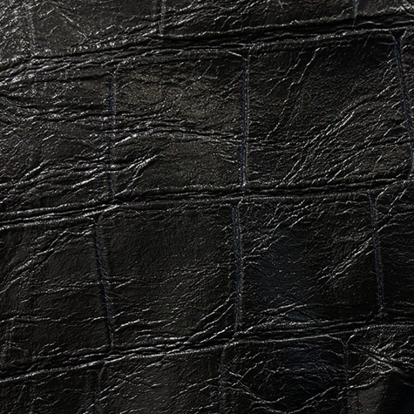 A person wears the MEIMEIJ Taffeta Balloon Skirt in shiny taupe, paired with a light blue long-sleeve shirt and black flats, standing on a light carpet against a white background.