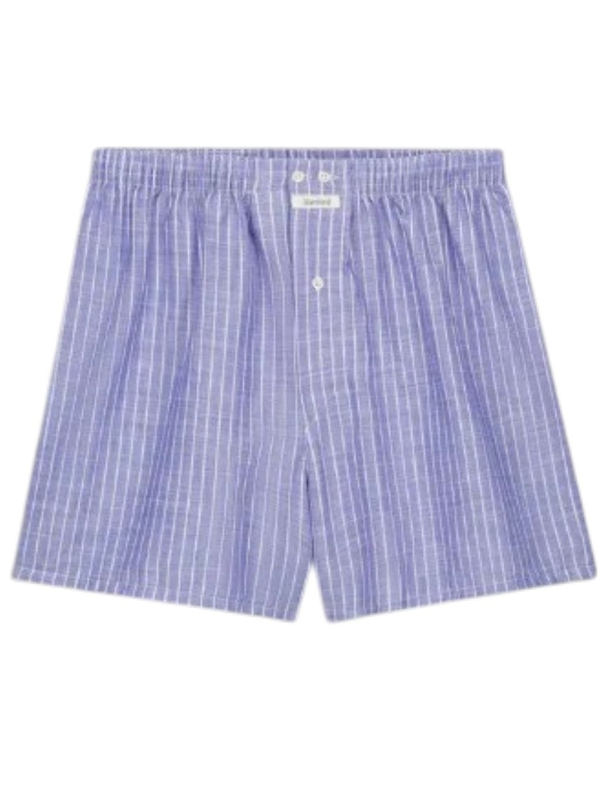 HARTFORD - COTTON BOXER SHORTS: Light blue men's boxer shorts with white pinstripes, elastic waistband, and single button fly by HARTFORD. Crafted for sustainability and shown on a plain light gray background.