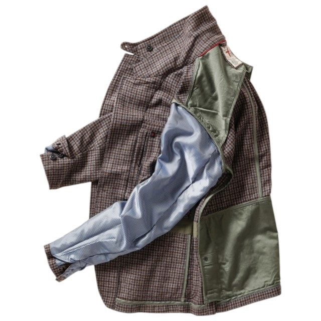 The RELWEN Heritage Trap Blazer in Brown and Blue Check features a brown and black plaid pattern, reminiscent of a classic check blazer, shown from the back with buttoned cuffs and a subtly wrinkled texture, laid flat on a white background.
