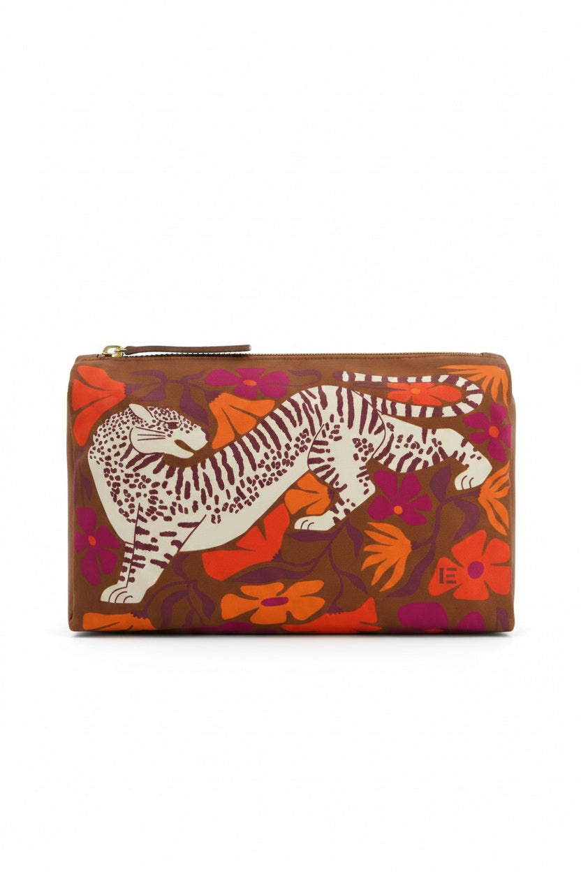 The INOUI EDITIONS - PANTEO COSMETIC BAG by INOUI is a brown zippered pouch made in India, showcasing an illustrated white and brown tiger among orange, red, and purple floral patterns on the front.