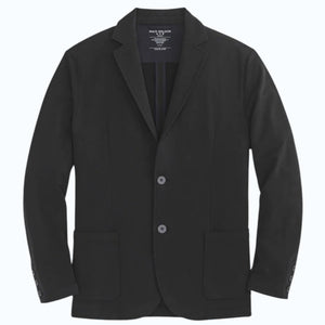 A person in a navy shirt holds open the MACK WELDON ACE BLAZER IN TRUE BLACK, revealing its comfortable, machine-washable design with an inside pocket and inner lining.