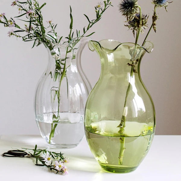 The VIETRI Hibiscus Vertical Flute Vase Large features a clear, rounded body with a wide, flared scalloped rim and stands on a flat base against a white background.