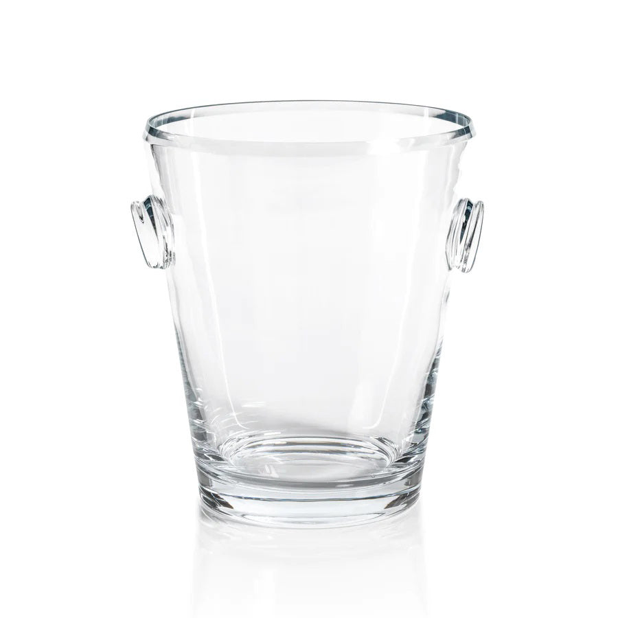 Introducing the LA SERENA BEVELED GLASS ICE BUCKET by ZODAX, a simplistic and functional design with two small handles on either side. Measuring 8.5 inches in height and 10 inches in diameter, this clear tapered cylindrical ice bucket is empty and set against a plain white background.