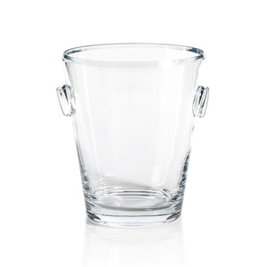 Introducing the LA SERENA BEVELED GLASS ICE BUCKET by ZODAX, a simplistic and functional design with two small handles on either side. Measuring 8.5 inches in height and 10 inches in diameter, this clear tapered cylindrical ice bucket is empty and set against a plain white background.
