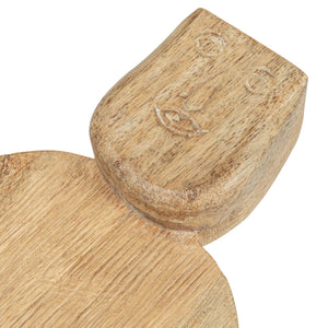 The CREATIVE COOP HAND-CARVED MANGO WOOD CHARCUTERIE/CUTTING BOARD WITH FACE HANDLE features a flat, rectangular shape, rounded edges, and rustic grain patterns for a handcrafted look.