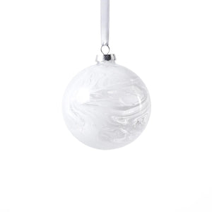 The ZODAX WATERCOLOR GLASS ORNAMENT IN WHITE is a round, marbled 4-inch Christmas ornament suspended by a thin silver ribbon against a plain white background.