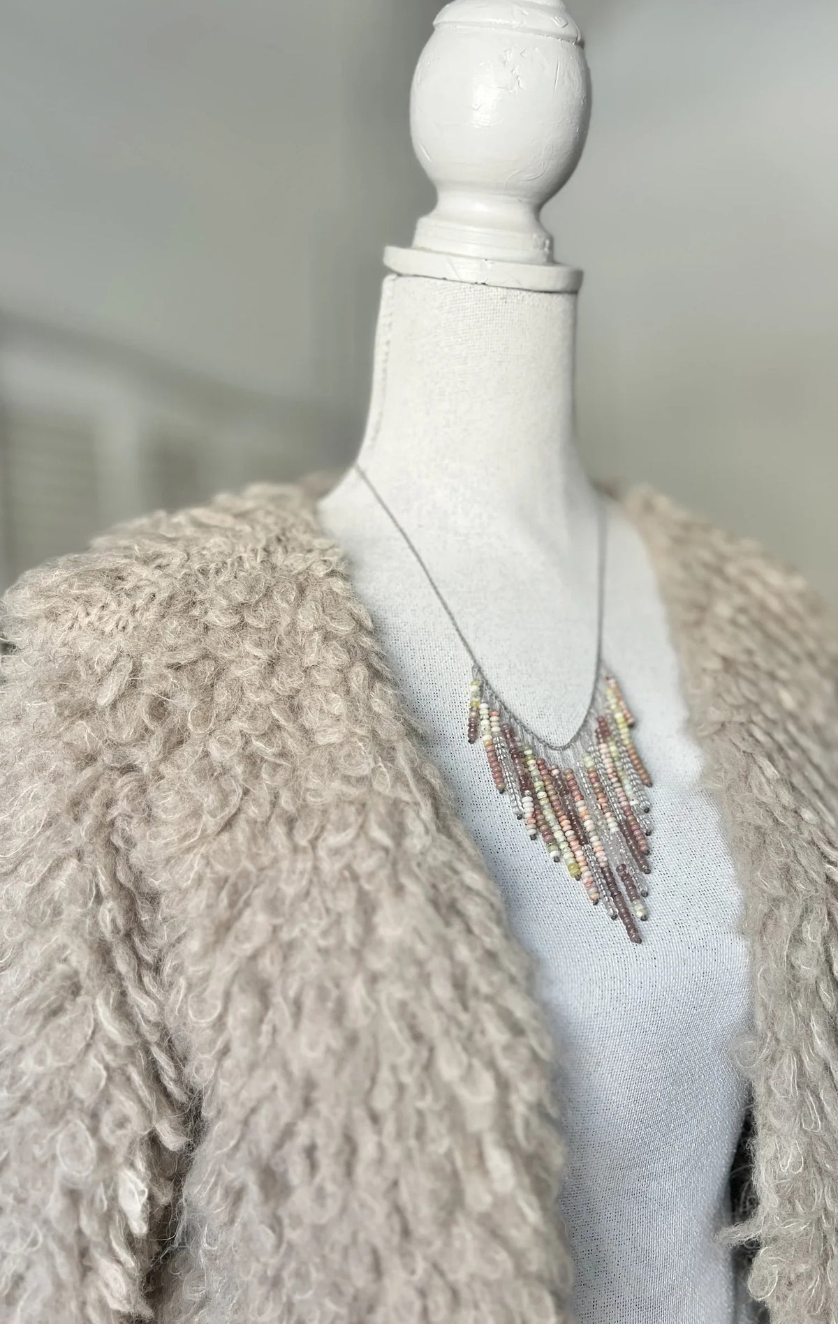 The ANN LIGHTFOOT Multi Gemstone Fringe Necklace features a silver chain with colorful gemstone fringe in pink, yellow, orange, green, and brown—perfect for adding playful charm to any look.
