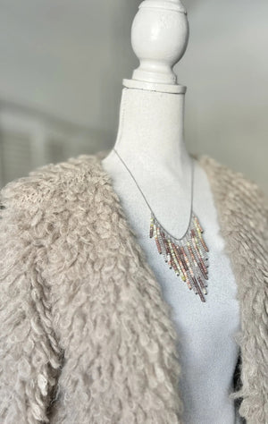 The ANN LIGHTFOOT Multi Gemstone Fringe Necklace features a silver chain with colorful gemstone fringe in pink, yellow, orange, green, and brown—perfect for adding playful charm to any look.