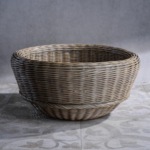 The MONTEVERDE RATTAN BOWL by ZODAX, a round and shallow natural brown wicker basket measuring 46.99 cm x 22.86 cm (18.5 in x 9 in), is displayed on a white surface.