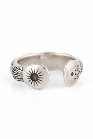 The GAS BIJOUX - SILVER LIANE JONC BIS RING, crafted by GAS BIJOUX, showcases a stunning bamboo motif with intricate engraved designs on the interior. It easily adjusts to fit you perfectly and is presented on a simple beige background with a delicate shadow beneath.
