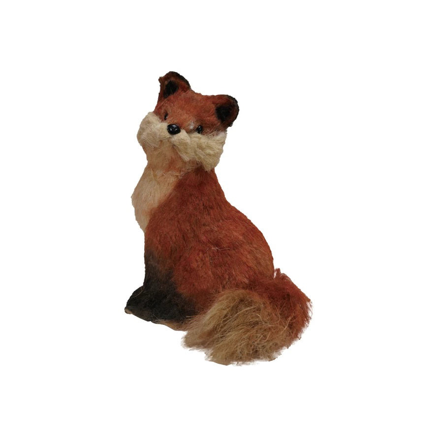 The CREATIVE COOP SISAL SITTING FOX features reddish-brown fur, black-tipped ears, a bushy tail, and tan accents—an adorable plush decor piece for any space.