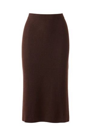 A woman models the KINROSS CASHMERE - RIB CASHMERE SKIRT with a matching brown, short-sleeve, high-neck sweater top and white sneakers with tan accents, standing against a plain white background.