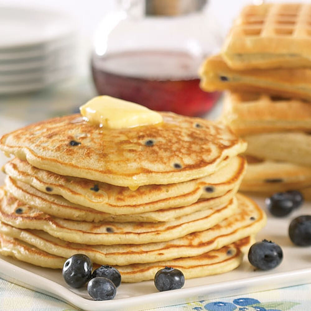 A 16 oz (453.6g) canister of STONEWALL KITCHEN - BLUEBERRY PANCAKE AND WAFFLE MIX, made with real Maine blueberries, featuring a photo of blueberry pancakes topped with butter and syrup.