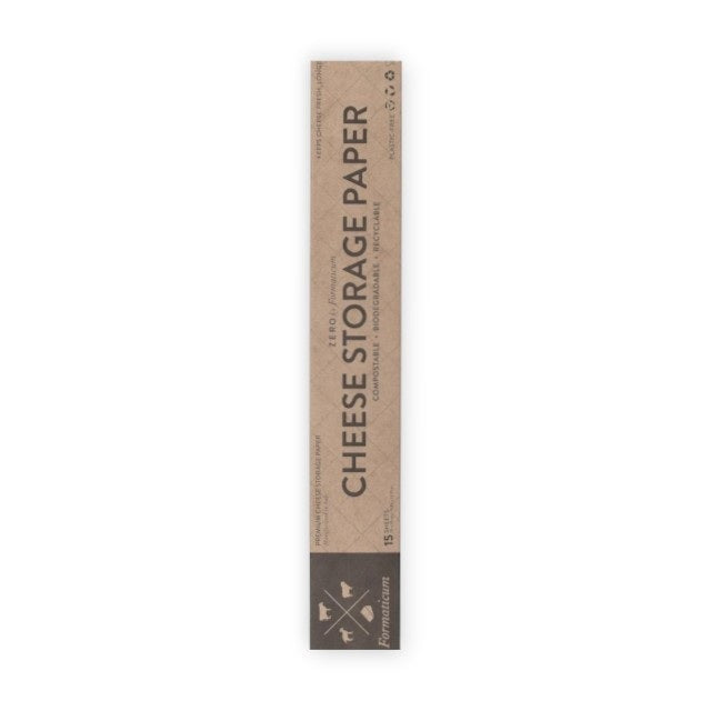 A hand holds a sheet of FORMATICUM - ZERO CHEESE STORAGE PAPER with green illustrations, next to a brown FORMATICUM box. The partially unrolled cheese storage paper is ideal for keeping cheese fresh at home.