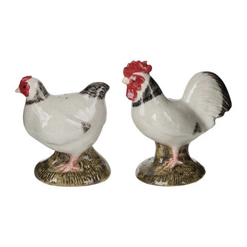 The QUAIL DESIGNS Sussex Chicken Salt and Pepper Set features two handpainted stoneware figurines—a white hen and rooster with black markings—standing on green bases. Dishwasher safe.