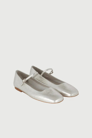 The AUGUSTA - JULIETA MARY JANE by AUGUSTA is a black leather flat shoe featuring a slender, adjustable strap across the top and a low wooden heel. With its renewed silhouette, slightly pointed toe, and minimalist design, this handcrafted Spanish shoe is presented against a plain, light gray background.