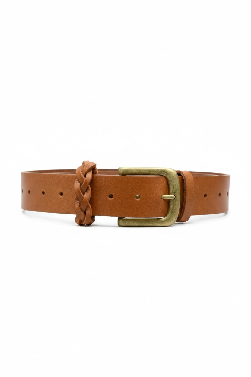 The ADA TOUGH GUY BELT is a handcrafted piece featuring Argentinian brown leather, a brass buckle, and a braided keeper. It includes multiple holes for sizing adjustments and is showcased on a plain white background.