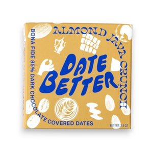 Three DATE BETTER - ALMOND JAVA CRUNCH COVERED DATES, by DATE BETTER SNACKS, arranged on a dark slate surface offer a deliciously healthy candy alternative.