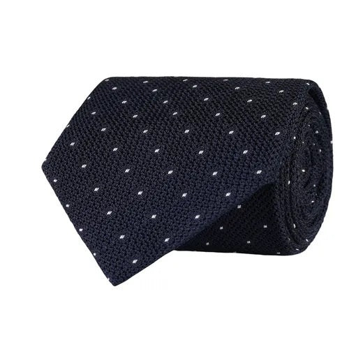 The AMANDA CHRISTENSEN Polka Dot Grenadine Woven Silk Tie in Navy, featuring expertly crafted small white polka dots, showcases exquisite Italian craftsmanship against a plain white background.