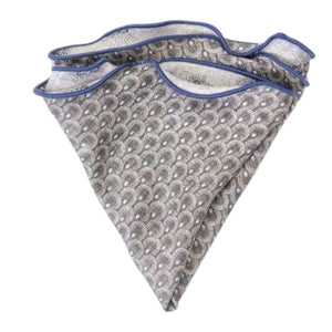 The EDWARD ARMAH Silk Reversible Pocket Circle in Gray Foulard/Feather features a light gray geometric pattern with blue accents and border, shown folded on a white background.