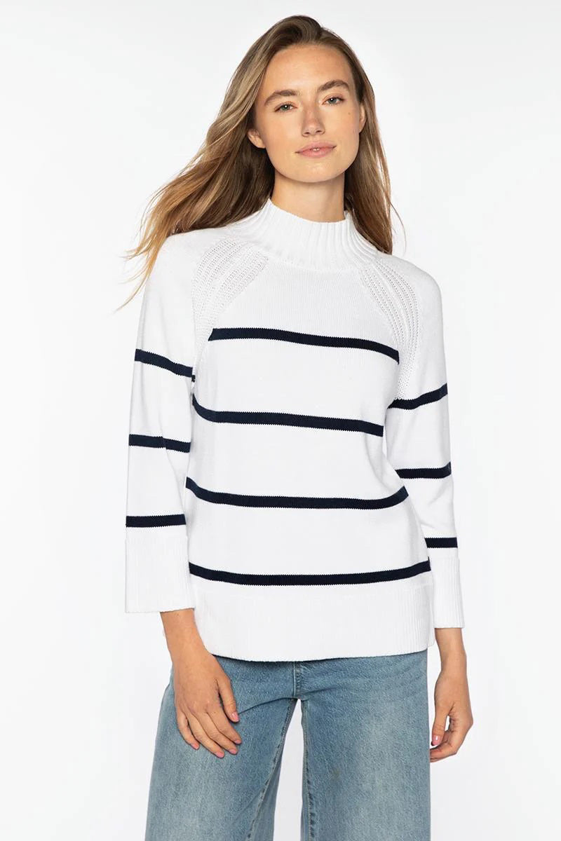 A woman models the KINROSS CASHMERE Stripe Easy Funnel Neck Cotton Sweater in white and navy, paired with blue jeans, standing against a plain white background and looking confidently at the camera.