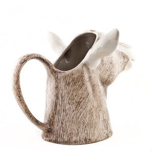 The QUAIL CERAMICS - GOAT JUG MEDIUM by QUAIL DESIGNS is a handpainted stoneware mug shaped like a goat’s head with detailed brown and white fur, upright ears, and a neck-shaped handle inspired by the British Toggenburg Goat jug.