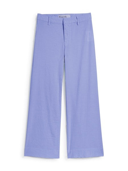Woman standing and smiling, wearing a white t-shirt, FRANK &amp; EILEEN Wexford Wide Leg Linen Pant in Wisteria, and white sneakers against a plain light background.