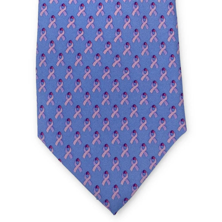 The BIRD DOG BAY - CARE FOR A CURE™ Silk Tie in Light Blue features a rolled-up silk design with a repeating pink ribbon pattern supporting breast cancer, by BIRD DOG BAY.