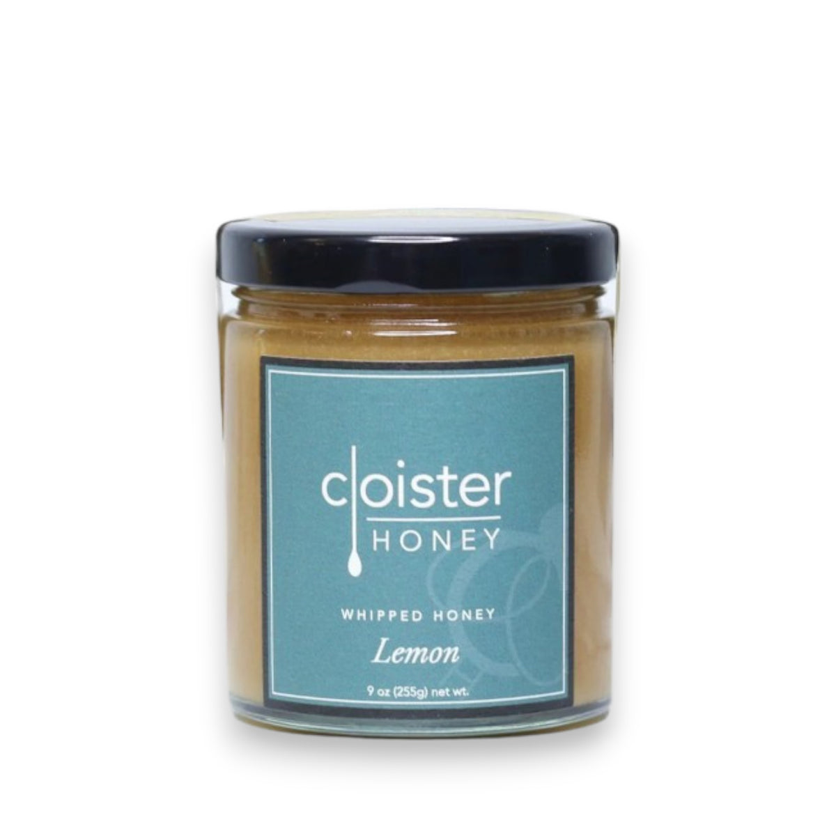A 9-ounce jar of Cloister Honey Whipped Honey with Lemon, featuring a black lid and a blue label that displays the brand name, product type, and flavor. The light brown honey inside carries a hint of citrus lemon.