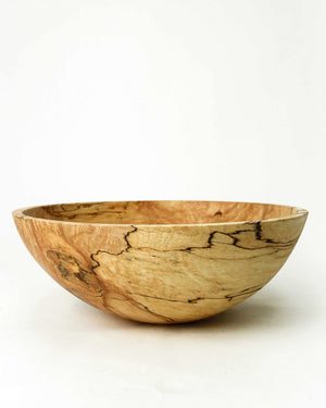 The SPENCER PETERMAN Classic Round Spalted Maple Bowl 18" by PETERMANS BOARDS & BOWLS INC features a handcrafted, smooth, rounded design and unique natural grain patterns, displayed against a plain white background.