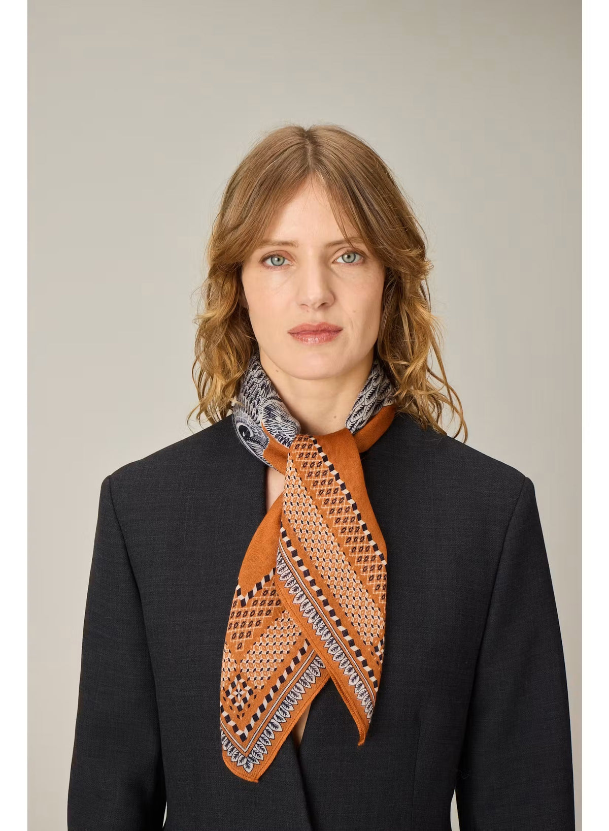Showcasing a drawing of a striped cat and an intricately detailed owl perched side by side on a branch, set against a terracotta brown background with an ornate patterned border, the INOUI EDITIONS - CHOUETTE SQUARE MODAL SILK SCARF IN TERRACOTTA by INOUI is expertly crafted in India. Measuring 70 x 70 cm, this unique scarf features intricate details reminiscent of traditional artistry.