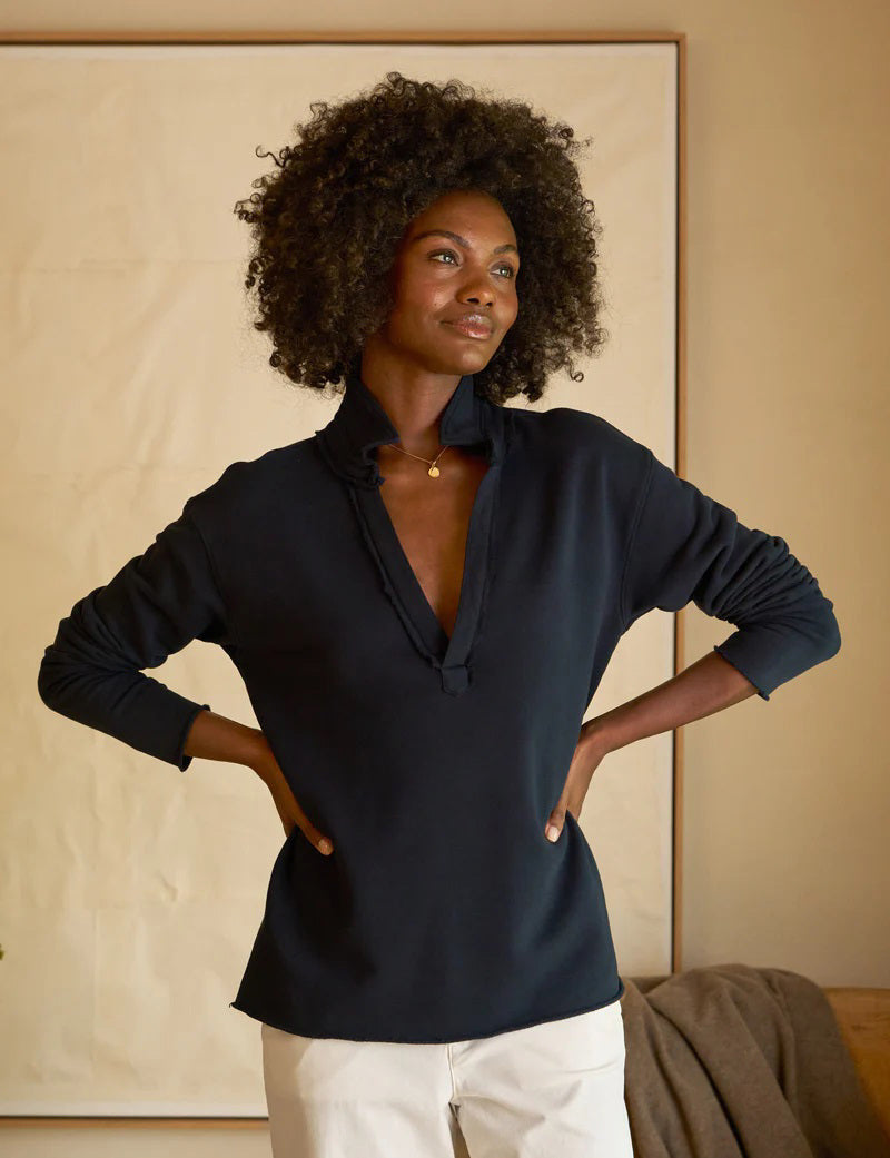 Introducing the FRANK &amp; EILEEN - Patrick Popover Henley Triple Fleece by FRANK &amp; EILEEN. This dark-colored shirt features a collar and a deep V-neck opening, along with long sleeves for added warmth. Made from luxuriously soft and comfortable Triple Fleece fabric, the hem and sleeves have a slightly distressed, casual look. Easy to care for, this stylish Henley is machine washable and showcased against a plain, light background.
