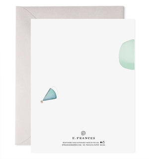 The E. FRANCES - POGO PANDA greeting card by E. FRANCES PAPER features a panda on a pogo stick with a green balloon and “Happy Birthday” below, printed on heavyweight paper and paired with a grey envelope behind the card.