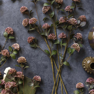 A single artificial flower stem with green leaves and clusters of small pink blossoms, ideal for bouquets or pairing with ABIGAIL AHERN - EUCALYPTUS BERRY from ABIGAIL AHERN.