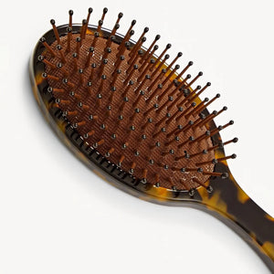 The MACHETE Everyday Detangling Hair Brush in Tortoise is a brown tortoiseshell Italian acetate brush with a dark bristle bed and rounded tips, shown against a plain white background.