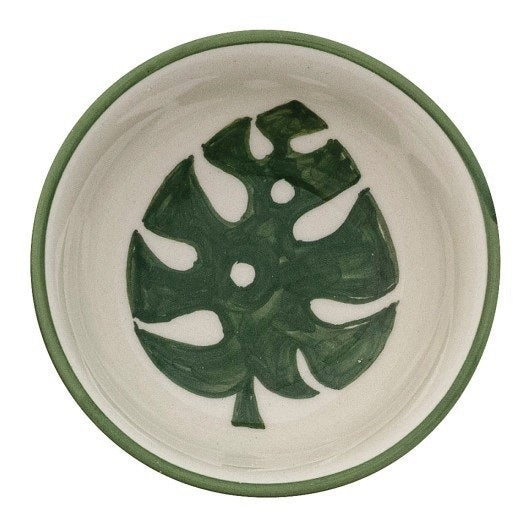 CREATIVE COOP's HAND-PAINTED STONEWARE BOWLS WITH BOTANICAL DESIGN, some holding green peppers or grains, are arranged on a light beige surface—each bowl highlights its unique handcrafted artistry.